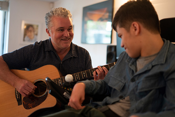 Music therapist and guitar with client